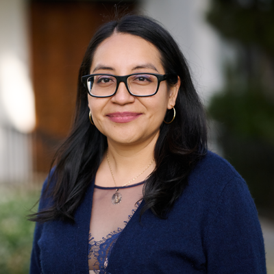 Delmy Ruiz, Program Associate, stands in front of Sacred Heart Chapel